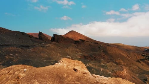 Woman Hiker Exploring Volcanic Desert Landscape