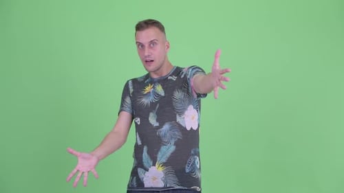 Enthusiastic Young Man Gesturing with Open Arms