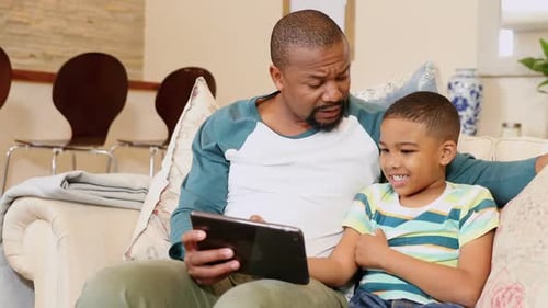 Happy Father and Son Using Tablet Together