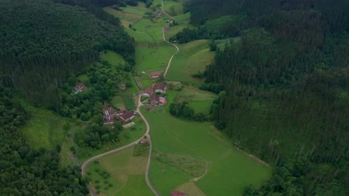 Aerial View of Green Valley with Farm Buildings