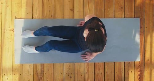 Woman Does Core Exercise on Mat Overhead Shot