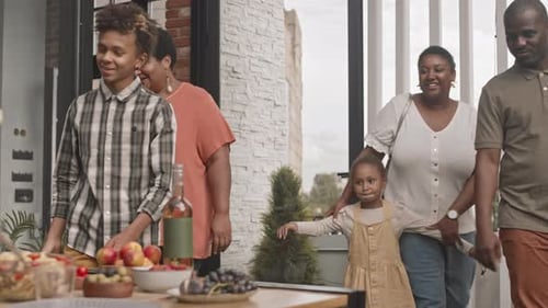 Family Gathering Outdoors for Meal on Patio