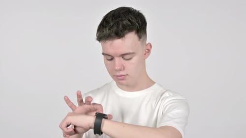Junger Mann surft auf Smartwatch im Internet, weißer Hintergrund