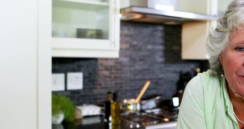 Senior Woman Smiling in Kitchen Close Up