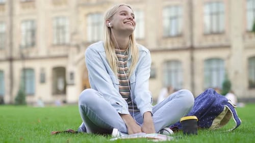Woman Listening to Music and Studying Outdoors