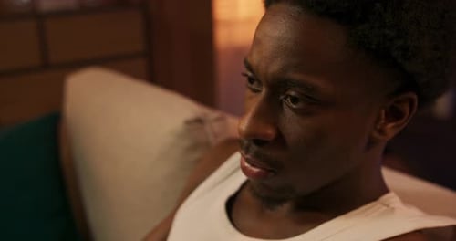 Young Man Relaxing at Home Playing Video Game