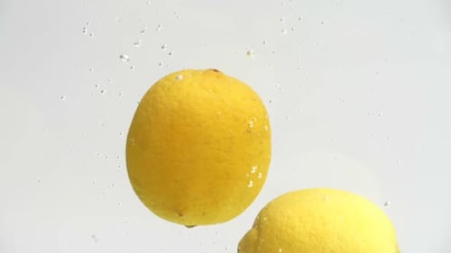 Lemons Falling into Water Creates Bubbles