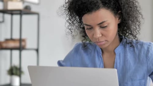Woman Working on Laptop Computer at Home