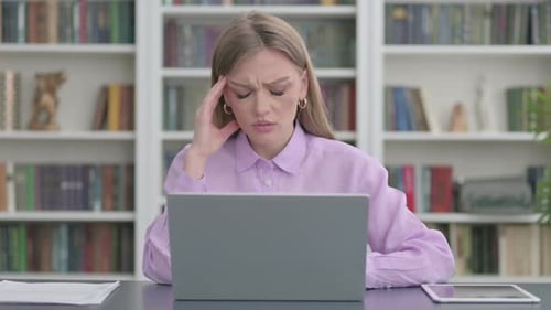 Stressed Woman Working on Laptop at Desk