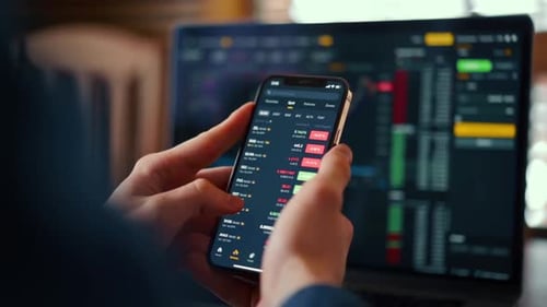 Trader Using Phone with Stock Exchange App