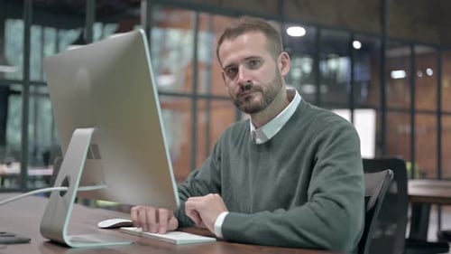 Working Young Man Pointing Finger at Camera