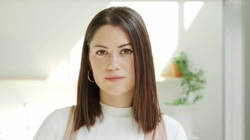 Closeup of a Female Entrepreneur Looking at Camera in an Office or Coworking