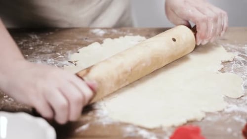 Rolling Dough on Wooden Table for Baking