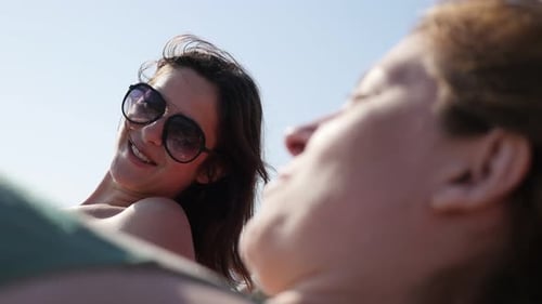 Couple of female on the beach casual chit-chat scene 4K 2160p 30fps UltraHD footage - Two women enjo