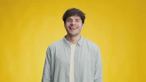 Smiling Man Laughing on a Yellow Background