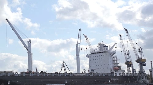 Cargo Ship at Port with Towering Cranes