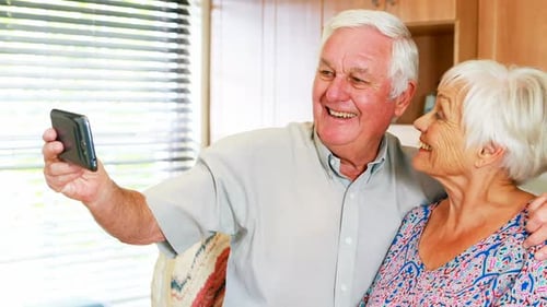Senior Couple Taking Silly Selfies in Kitchen