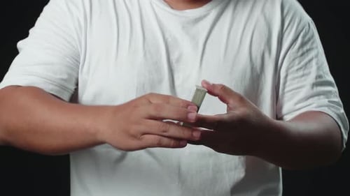 Person Shuffles Deck of Cards with Spiral Design