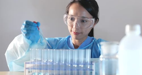 Scientist Working with Test Tubes in Lab