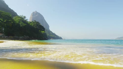 Static shot of gentle waves washing up on Red Beach in Rio.