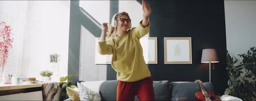 Young Woman Dancing to Music at Home