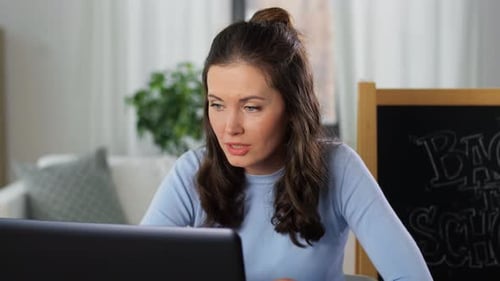 Woman Working on Laptop Computer From Home