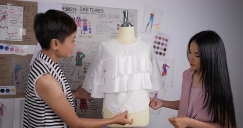 Close up of Teacher woman teaching fashion student girl measuring tape on puppet in studio.