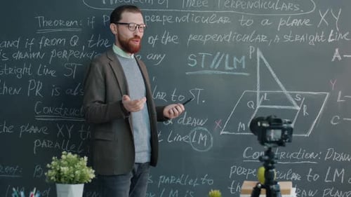 Math Teacher Explains Geometry Theorem at Chalkboard