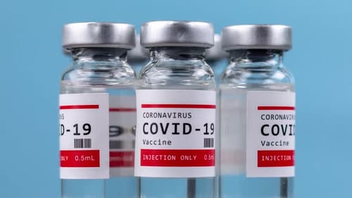 COVID-19 Vaccine Vials on Blue Background