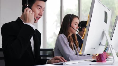 Diverse Call Center Workers Typing At Their Desks