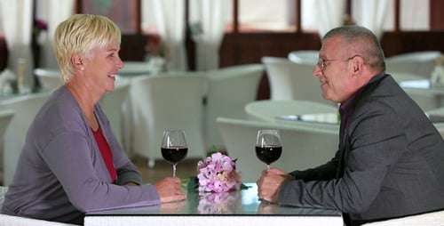 Mature Couple Toasting with Wine at Restaurant