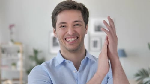 Smiling Man Clapping His Hands in Approval