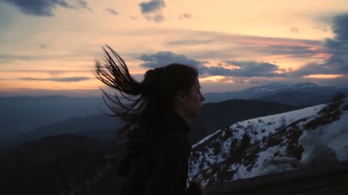 Woman Running on Mountain Road at Sunset