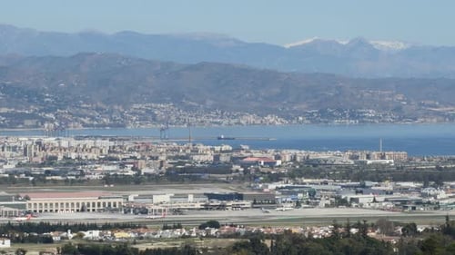 Landscape of Airplane Taking Off with Coast City at Background