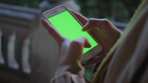 Businesswoman Typing on Cellphone with Green Screen