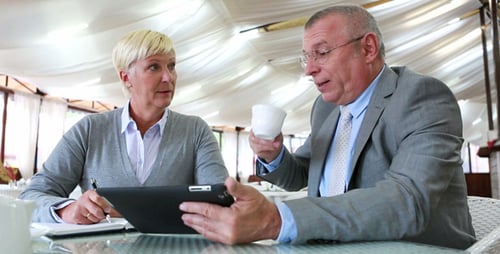 Business People Discussing Project on Tablet