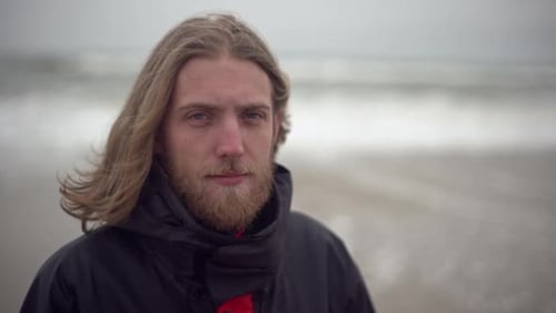 Man with Blonde Hair on Overcast Beach