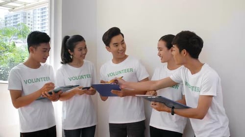 Enthusiastic Volunteers Discussing Plans Indoors