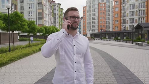 Man Talking on Phone in Urban Setting
