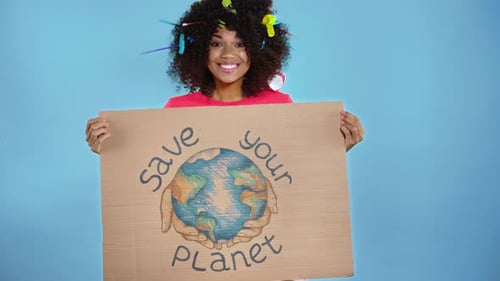 Young Adult Promotes Saving The Planet With Sign
