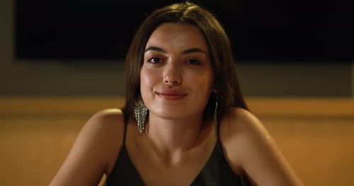 Smiling Brunette Woman with Earrings Close Up