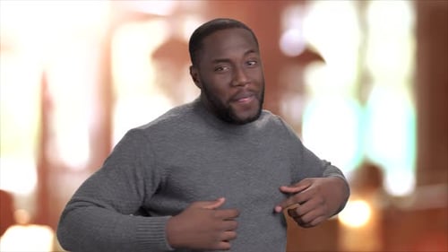 Man Gesturing and Speaking in Mid Shot