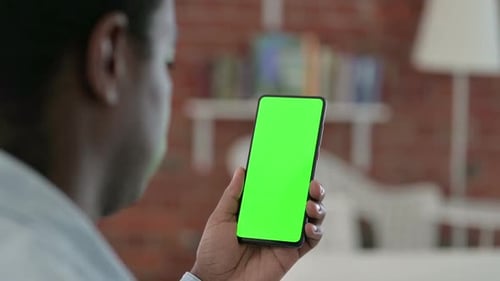 African Man Holding Smartphone with Chroma Key Screen