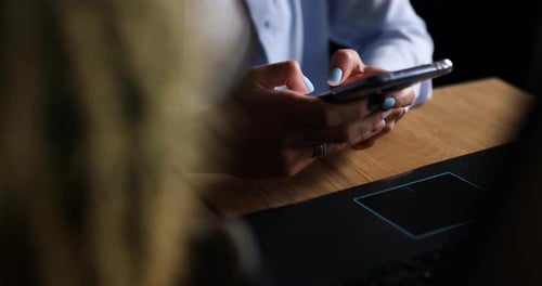 Woman Using Smartphone at Desk Close-Up