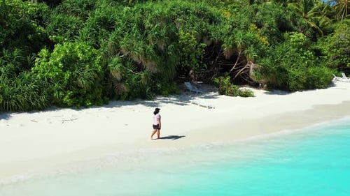 Sexy fun woman on photoshoot having fun on the beach on paradise white sand and blue background 4K