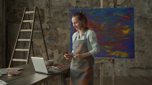 Artist Video Conferencing While Painting in Studio