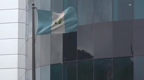 Guatemala National Flag Waving On Pole In Corporate Setting