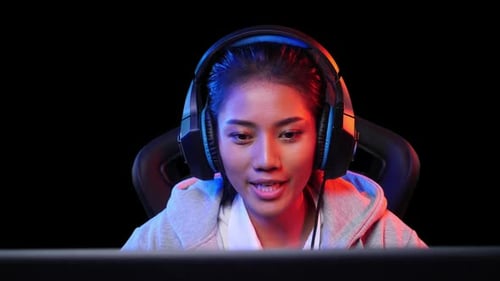 Young Adult Woman Gaming with Headphones