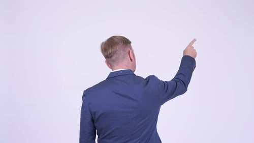 Rear View of Blonde Businessman Pointing Finger and Directing