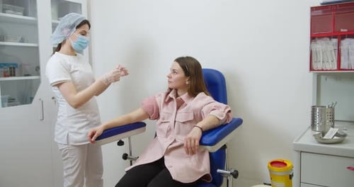 Medical Professional Drawing Blood from Adult Woman's Arm